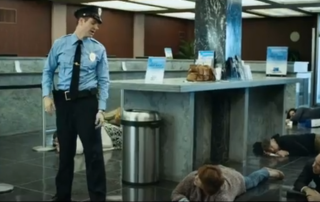 security guard standing in bank and customers on ground