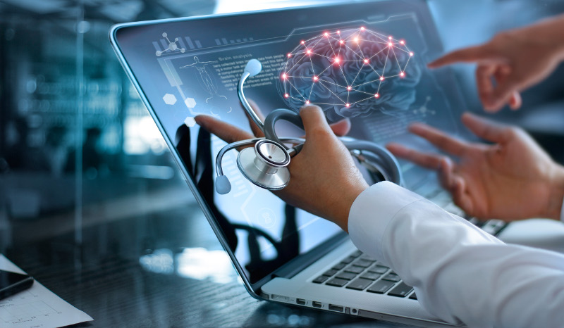 doctors pointing to a laptop screen of brain illustration