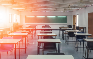 empty classroom with desks and chalk board