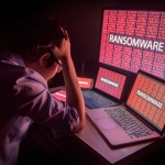 person frustrated by ransomware attack on desktop screen