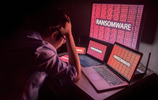 person frustrated by ransomware attack on desktop screen