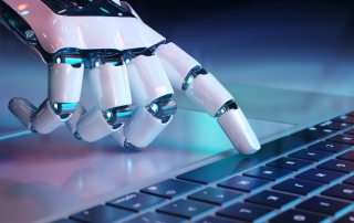 white robotic hand touches the spacebar of a computer keyboard with its pointer finger