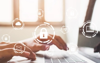 Legal compliance after ransomware. The image shows a close-up of someone typing on a laptop keyboard. Overlaid on the image are various icons representing cybersecurity, including a padlock, a cloud, an email symbol, and a laptop, all surrounded by circles, giving the impression of data protection or encryption.