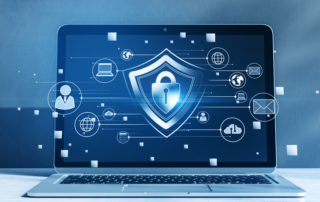 Ransomware phishing training for employees. A laptop screen displays a glowing shield with a padlock at its center. Icons representing user profiles, email, cloud storage, and more are connected around it, emphasizing cybersecurity and digital connections.