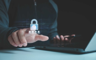 Ransomware incident playbook creation. A person wearing dark clothing is interacting with an invisible touchscreen displaying a glowing padlock and a hidden password represented by asterisks (****). They hold a smartphone in their other hand, suggesting multi-device authentication or secure login procedures.