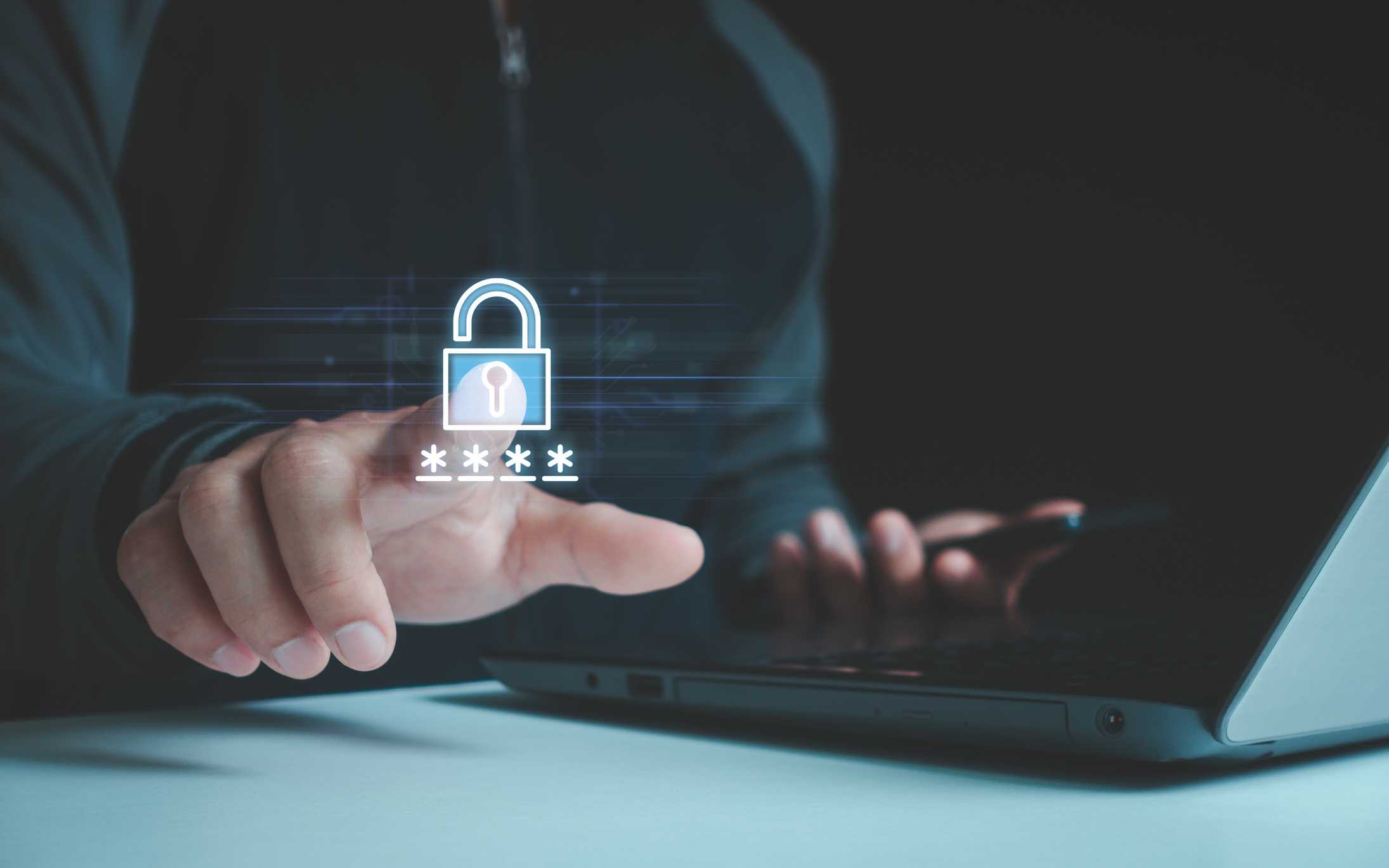 Ransomware incident playbook creation. A person wearing dark clothing is interacting with an invisible touchscreen displaying a glowing padlock and a hidden password represented by asterisks (****). They hold a smartphone in their other hand, suggesting multi-device authentication or secure login procedures.