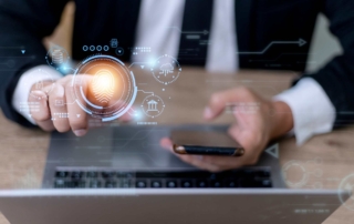 BYOD Endpoint Protection Strategies. A businessperson pointing at a glowing orange fingerprint scanner hologram while holding a smartphone, with faint futuristic interface graphics around the image.