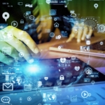 Disaster Recovery for Enterprises. Hands typing on a tablet or laptop while surrounded by floating digital icons like locks, charts, and mail envelopes, symbolizing data, networks, and cybersecurity.