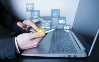 SMB Cybersecurity Governance. A close-up shows a person using a smartphone and a laptop simultaneously. Hovering above the phone are translucent icons for e-commerce—such as a shopping cart, a credit card, and a Wi-Fi symbol. The person appears to be tapping the phone screen, symbolizing mobile payments, online shopping, or digital commerce integration.