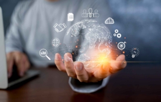 Secure DevOps Integration. A person in business attire sits behind a laptop. In the foreground, their hand is outstretched, and a glowing digital globe hovers above it. Around the globe are icons for various technologies—cloud computing, gears, lightbulb, graphs, and network connections—implying innovation, global communication, or digital transformation.