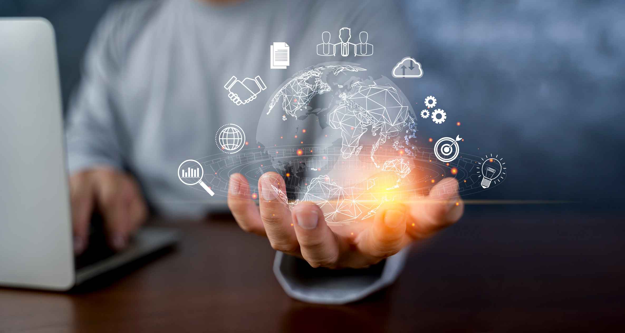 Secure DevOps Integration. A person in business attire sits behind a laptop. In the foreground, their hand is outstretched, and a glowing digital globe hovers above it. Around the globe are icons for various technologies—cloud computing, gears, lightbulb, graphs, and network connections—implying innovation, global communication, or digital transformation.