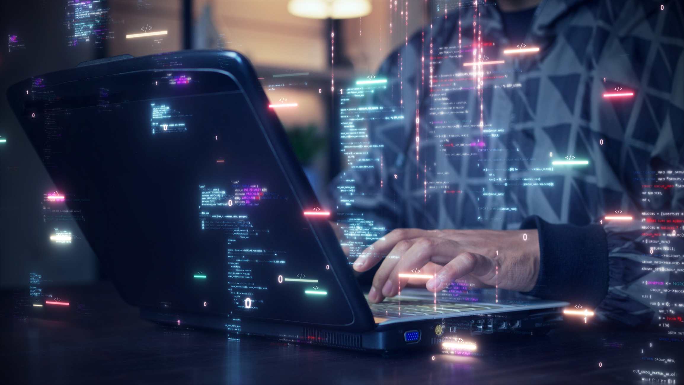 Cyber Threat Modeling Techniques. A person typing on a laptop in a dimly lit room. Bright, multicolored lines of code and data streams appear as glowing overlays, giving a sense of high-tech programming or cyber activity.