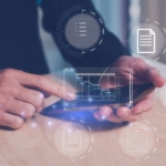 Honeypot Cyber Deception Tools. A close-up of a person in business attire using a smartphone on a desk. The screen appears to project a holographic interface showing multiple document icons floating in the air. It evokes a futuristic concept of secure digital file access or cloud document management.