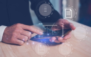 Honeypot Cyber Deception Tools. A close-up of a person in business attire using a smartphone on a desk. The screen appears to project a holographic interface showing multiple document icons floating in the air. It evokes a futuristic concept of secure digital file access or cloud document management.