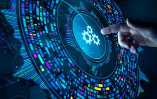 Hybrid work ransomware risk management. A finger points toward a large circular gear icon at the center of a glowing data visualization composed of radiating lines and multicolored digital streams. This image represents automation, system configuration, or digital orchestration.