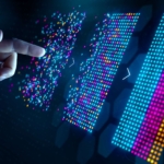 Ransomware Cyber Insurance Planning. A hand reaches toward multicolored vertical digital bars arranged in rows, appearing almost like audio waveforms or data blocks. The futuristic setting implies data analysis, AI processing, or interactive dashboards.