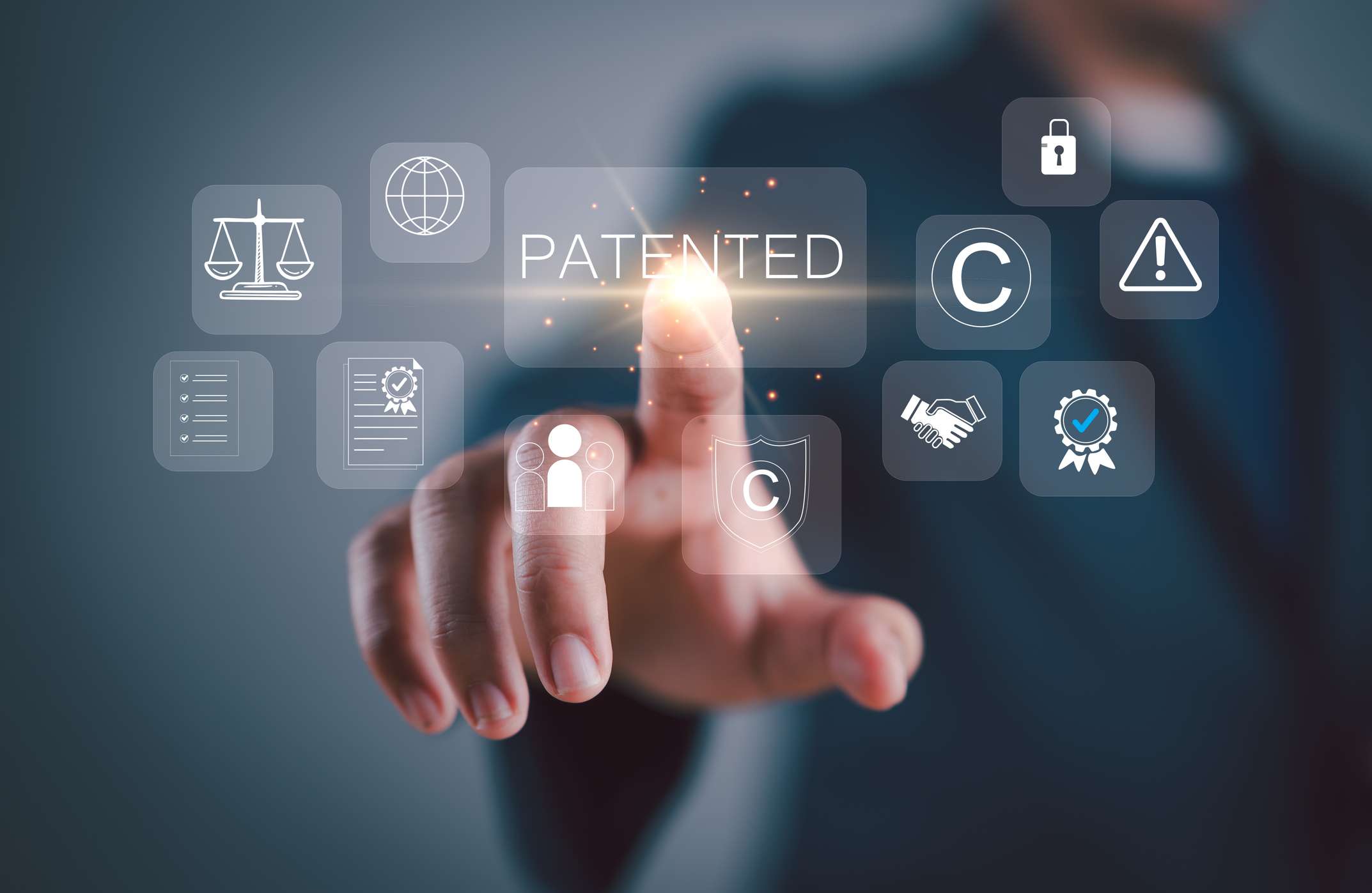 Immutable Architecture for Ransomware. A person pointing at a virtual screen displaying icons related to intellectual property—like a padlock, copyright symbol, checkmark, balance scale, and the word “PATENTED.” The background is dark with a business attire silhouette.
